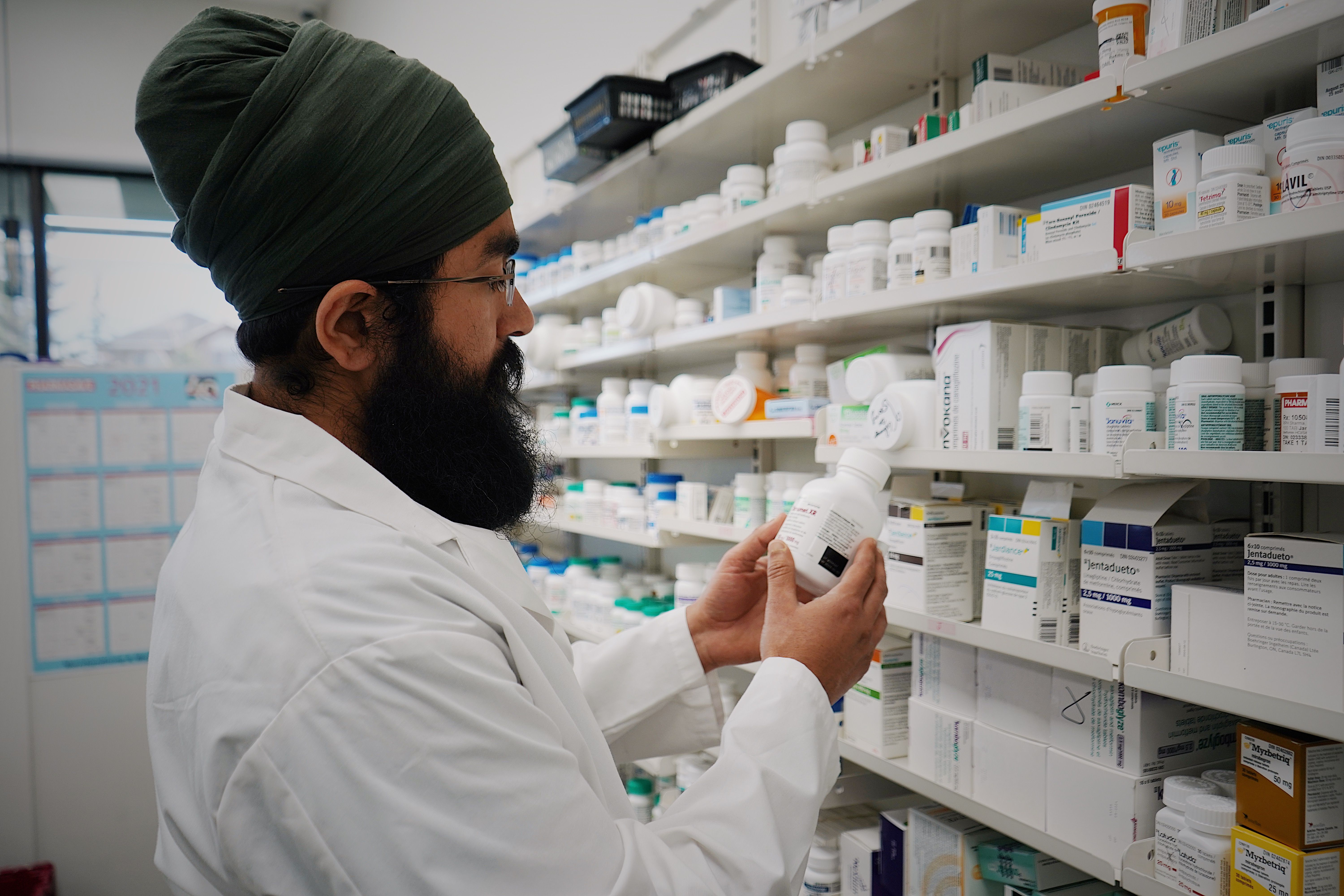 Pharmacist organizing medications in a pharmacy