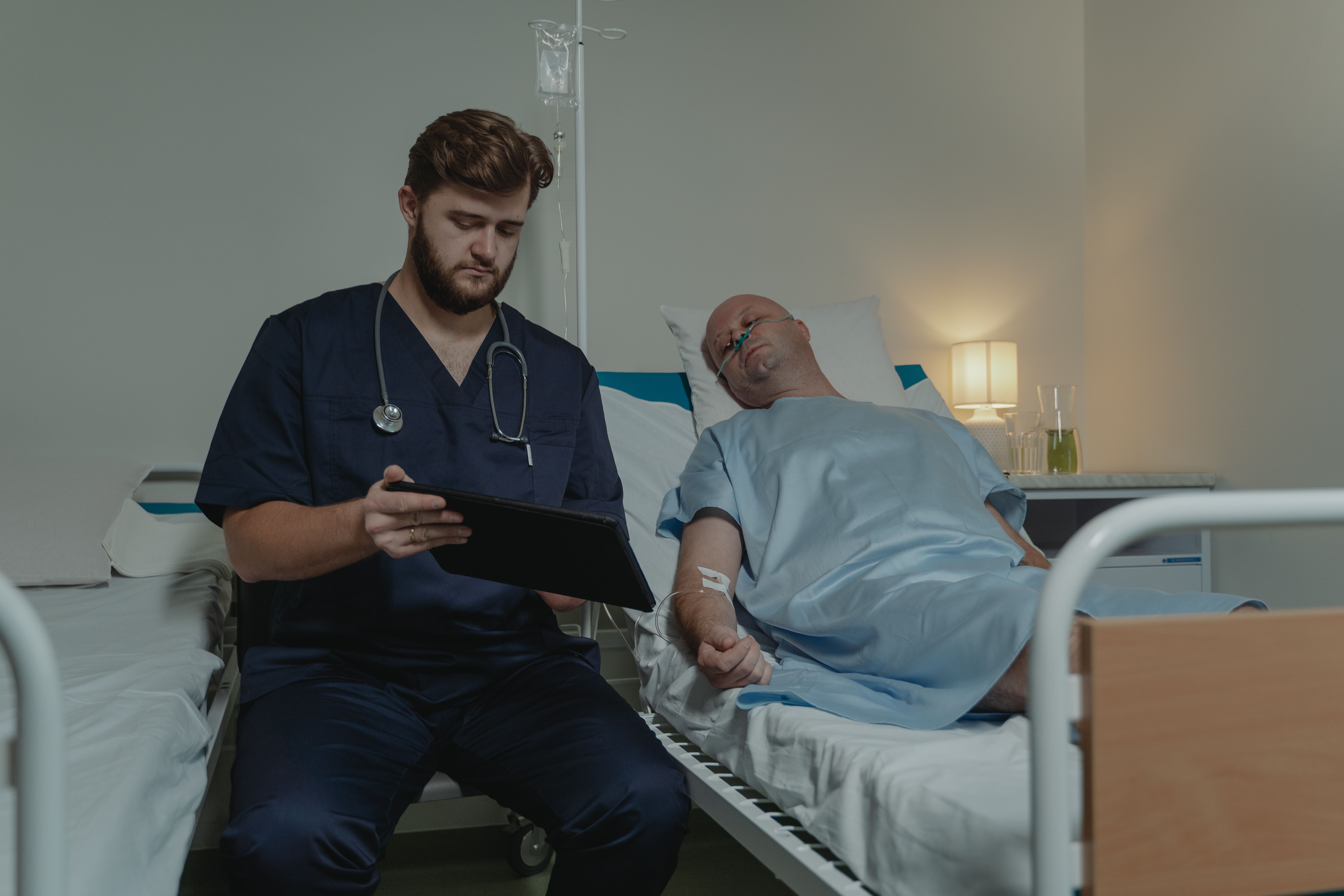 Patient care professional assisting a hospital patient